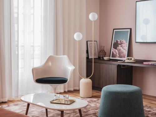 a living room with a chair and a table at Seven Hotel Paris in Paris