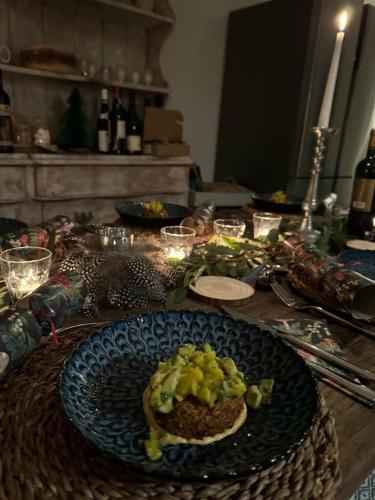 a table with a plate of food on top of it at Lower Barn House at Westerlands Farm Sleeps 11 in Graffham