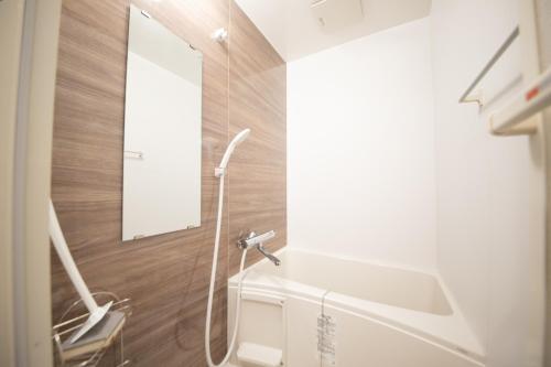 a bathroom with a shower and a sink and a mirror at 桜屋Sakuraya101 in Tokyo