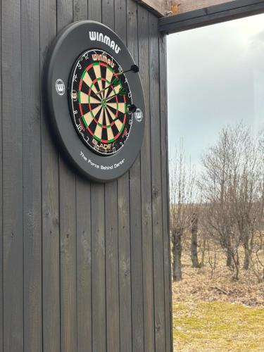a dart board on the side of a building at Eyja Mork - Aurora Igloo with shared Hot Tub, BBQ and kitchen - B2 in Stora Mork