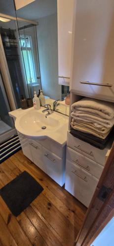 a bathroom with a white sink and a mirror at Eyja Mork - Stargazing Igloo with shared Hot Tub, BBQ and kitchen - B3 in Stora Mork
