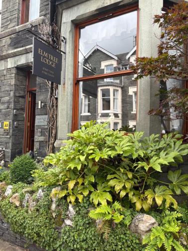 a sign in front of a window of a house at Elm Tree Lodge in Keswick