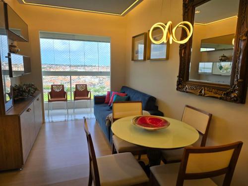 a living room with a table and a couch at Apartamento Residencial Serigy in Aracaju
