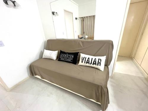 a bed in a room with two pillows on it at Alsina Mdq in Mar del Plata