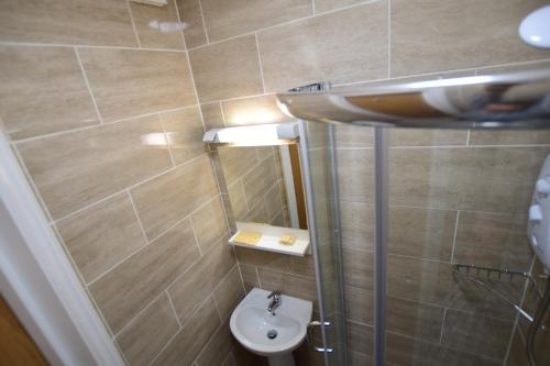 a small bathroom with a sink and a toilet at Woodlands Lodge Ilford in Ilford