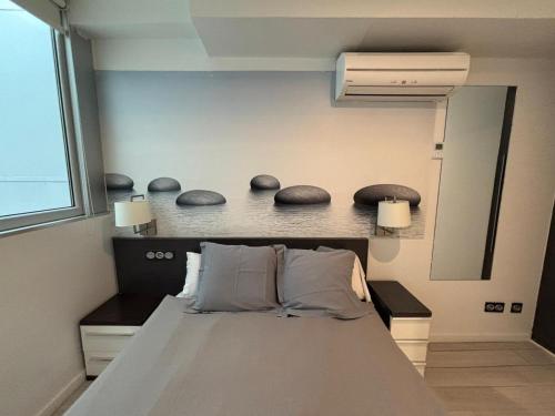 a bedroom with a bed with two pillows on it at Hotel Punta Monpas in Donostia-San Sebastián