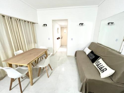 a living room with a couch and a table at Alsina Mdq in Mar del Plata