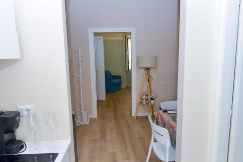 a room with a hallway with a table and chairs at L'Aurora Azzurra -Luxury Suites Sorrento coast in Piano di Sorrento
