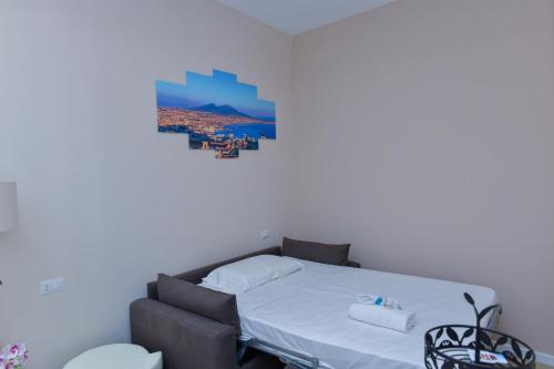 a bedroom with a bed and a picture on the wall at L'Aurora Azzurra -Luxury Suites Sorrento coast in Piano di Sorrento