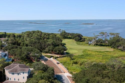 an aerial view of a golf course and the ocean at The Tipsea Turtle in Corolla