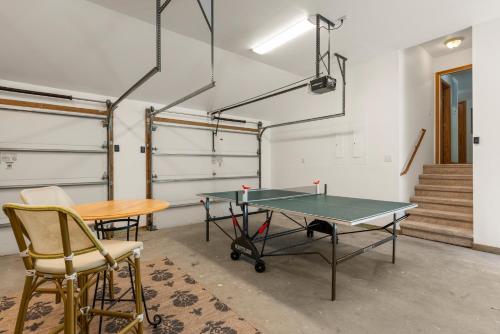 a ping pong table and chairs in a room at The Tipsea Turtle in Corolla