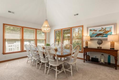 a dining room with a table and chairs at The Tipsea Turtle in Corolla