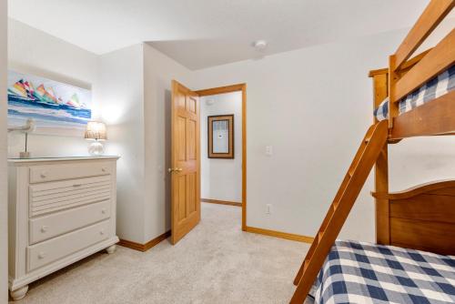 a bedroom with a bunk bed and a dresser at The Tipsea Turtle in Corolla