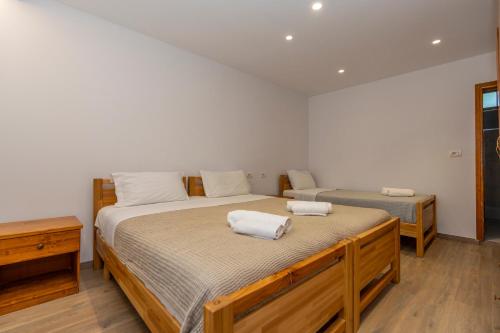 a bedroom with two beds with towels on them at Bujtina Berishta Theth in Theth
