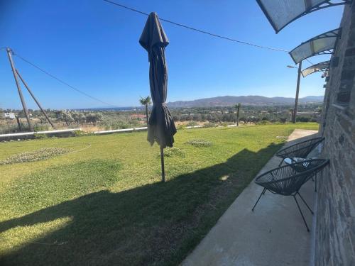 an umbrella on a pole in a yard at MIRAMAR KARYSTOS in Karistos