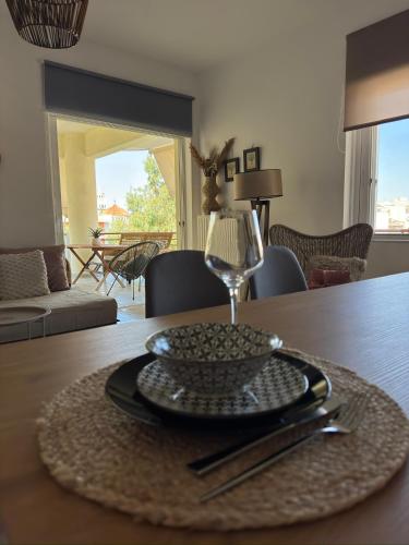 a table with a plate and a wine glass on it at Anemõessa in Korinthos