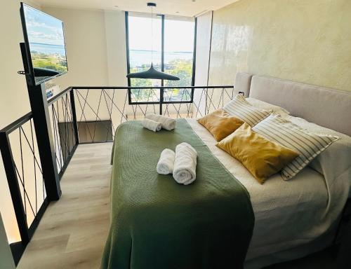 a bedroom with a bed with two towels on it at LOFTIER COSTANERA Depto 402 in Posadas
