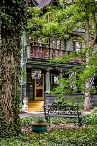 a house with a bench in front of it at Stone Soup Inn in Indianapolis