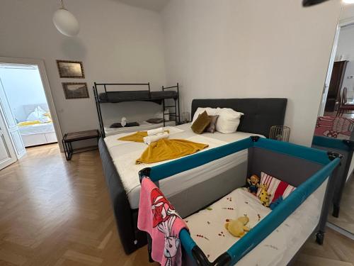 a bedroom with a bed with a baby crib at Apartments Opera in Vienna