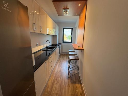 a kitchen with white cabinets and a counter top at Apartament Luxury nino in Focşani