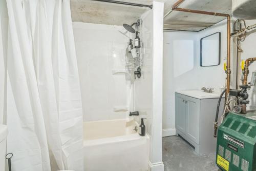 a bathroom with a shower and a toilet and a sink at Where Classic Charm Meets Modern Serenity in Pittsburgh