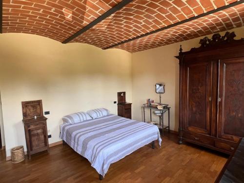 a bedroom with a bed and a brick ceiling at Charming Italian Home sleeps 6 Cantarana in Cantarana