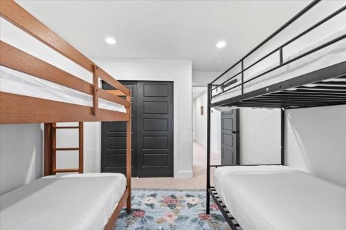 two bunk beds in a room with a hallway at Cherry Hill stay and play near lagoon in Kaysville