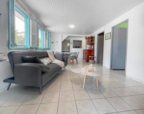 a living room with a couch and a table at Évasion créole à Grande Anse in Les Anses-dʼArlets