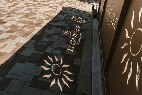a shadow of a sun on a sidewalk at Eleia Mirea in Monopoli