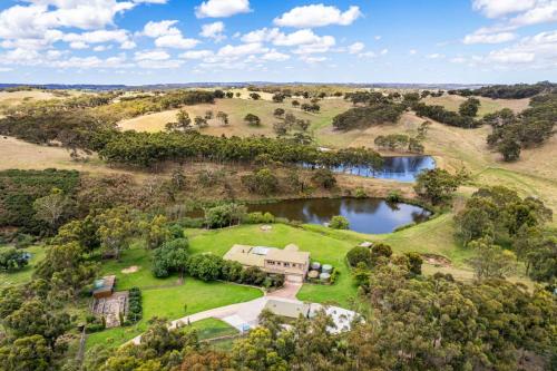 an aerial view of an estate with a pond at Secluded Stylish and Spacious The LostPlot 