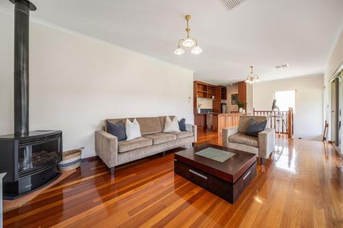 a living room with a couch and a fireplace at Secluded Stylish and Spacious The LostPlot 