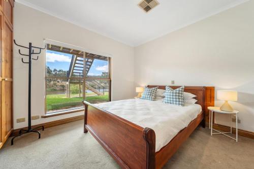 a bedroom with a bed and a large window at Secluded Stylish and Spacious The LostPlot 