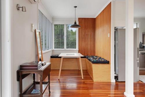 a kitchen with a table in the middle of a room at Countryside 4BR Family Home near Airport in Auckland