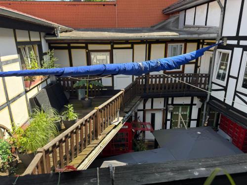 an image of a house with a blue raft on the stairs at Hotel Schwarzer Adler in Heilbad Heiligenstadt