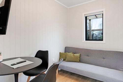 a living room with a couch and a table at Countryside 4BR Family Home near Airport in Auckland