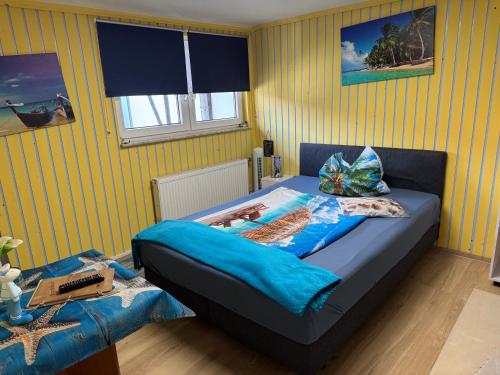 a bedroom with a bed with a blue comforter at Hotel Schwarzer Adler in Heilbad Heiligenstadt