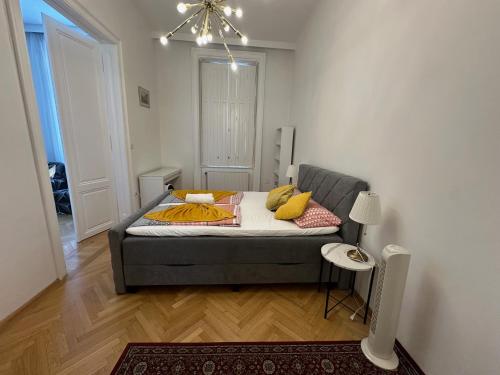 a bedroom with a bed with yellow pillows on it at Apartments Opera in Vienna