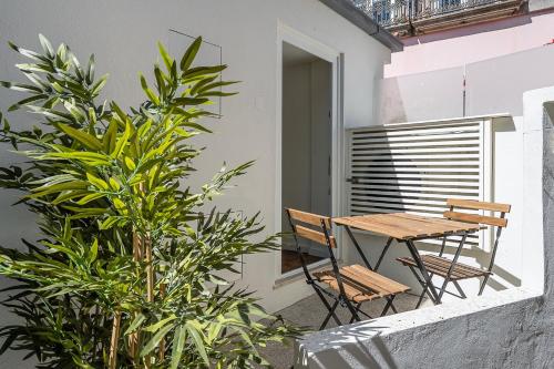 a patio with a wooden table and chairs on a balcony at GuestReady - Your Porto Hideaway in Porto