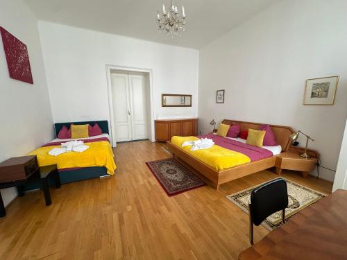 a room with two beds and a table at Apartments Opera in Vienna