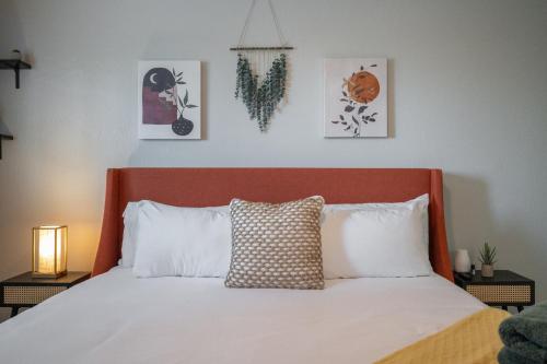 a bedroom with a white bed with a red headboard at Old Town Southwest Style 2BR Condo with Pool and Hot Tub in Scottsdale