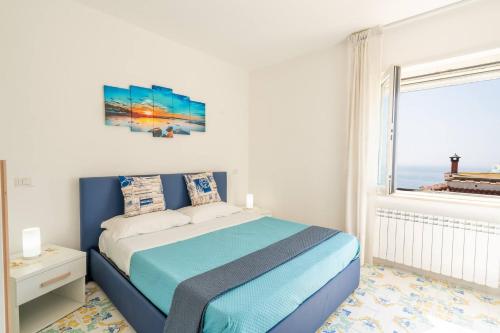 a bedroom with a bed with a view of the ocean at Blue Bell Residence - Amazing Capri view in Termini