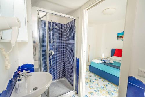 a bathroom with a shower and a sink at Blue Bell Residence - Amazing Capri view in Termini