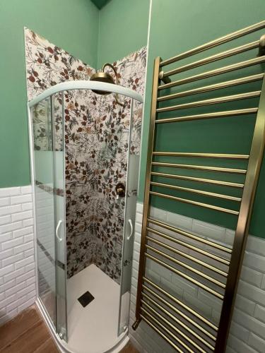 a shower with a glass door in a bathroom at Stresa Golf & Relax Romantik Suite in Gignese