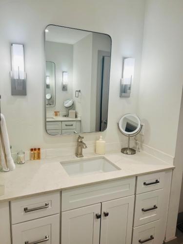 a bathroom with a sink and a large mirror at Mountain Views Retreat - Close to All - Private Sauna in Silverthorne