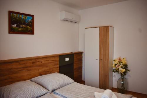 a bedroom with a bed and a vase of flowers at Orsi House in Szombathely