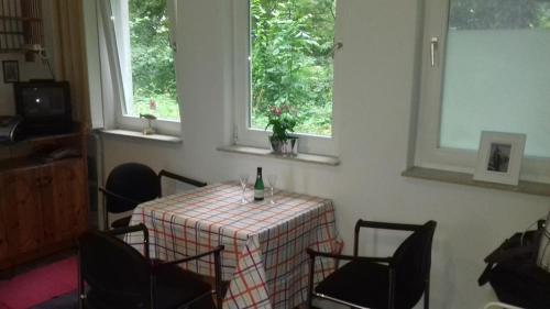 a dining room with a table with a bottle of wine at Simple Mini- Apartment City Park in Wismar