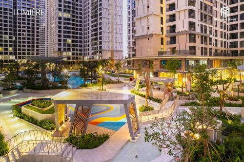 a park in a city with tall buildings at 2 phòng ngủ Solari nhìn công viên liền kề Vincom Mega Mall in Long Bình