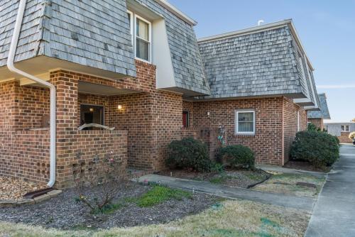 a brick house with a driveway in front of it at Villas M1 in Nags Head