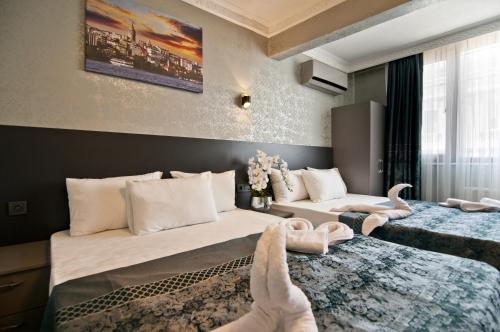 a hotel room with two beds with swans on them at Patio SeaShore in Istanbul