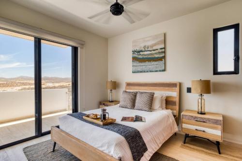 a bedroom with a bed and a large window at Group Apt 13 16, no view, 3BR, 12 pax in Cabo San Lucas